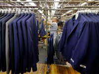 Cesar Berroa, performs the final press of completed suits ready to be shipped at the Joseph Abboud manufacturing plant in New Bedford, MA.   [ PETER PEREIRA/THE STANDARD-TIMES/SCMG ]